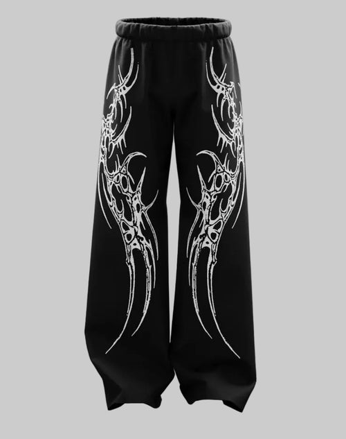 Black pants with white tribal designs on a gray background